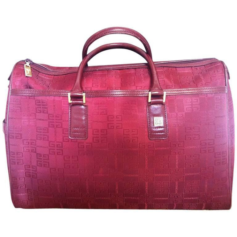 Vintage Givenchy travel duffle bag in classic monogram jacquard wine color with a logo pull and a golden charm. Unisex use large purse.