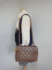 Vintage CHANEL cocoa brown caviar leather chain shoulder bag with golden sun flower CC mark charm. Classic bag