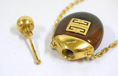 Vintage Givenchy gold chain necklace with gold tone logo motif and brown marble stone perfume bottle pendant top. Statement