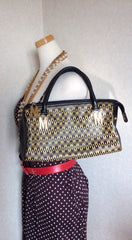 Vintage MOSCHINO black and ivory beige logo M print handbag, mini duffle bag with leather trimmings and golden M charms.