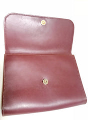 Vintage Cartier wine leather clutch bag, mini document purse with logo motif. Unisex bag from must de Cartier Collection.