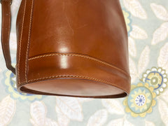 Vintage FENDI brown leather hobo bucket, shoulder bag with drawstring and iconic Janus medallion embossed motif at front. Unisex. Rare bag.