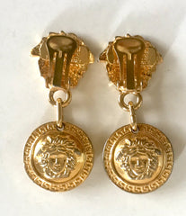 Vintage Gianni Versace gold tone medusa face motif dangle earrings. Must have Lady Gaga style jewelry piece. Great gift.