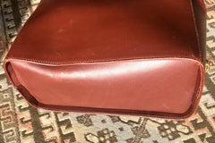 Vintage Salvatore Ferragamo brown leather purse with gold tone elegant closure. Featuring Ferragamo charms.