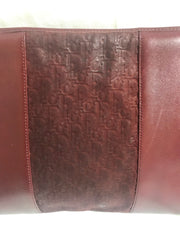 Vintage Christian Dior wine red leather clutch shoulder bag with engraved logo at center. Classic and beautiful purse from old dior era.