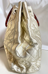 Vintage CHANEL campaign gold lamb leather hobo bucket bag with marble hoop handles and turn lock CC. 0412081