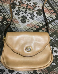 Vintage Gucci nude brown leather shoulder bag with golden and silver tone GG logo motif and wavy design flap. Classic purse.
