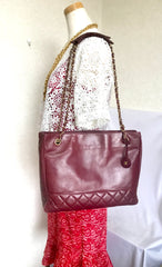 Vintage CHANEL wine leather tote bag with gold chain handles and CC motif charm. Classic purse.