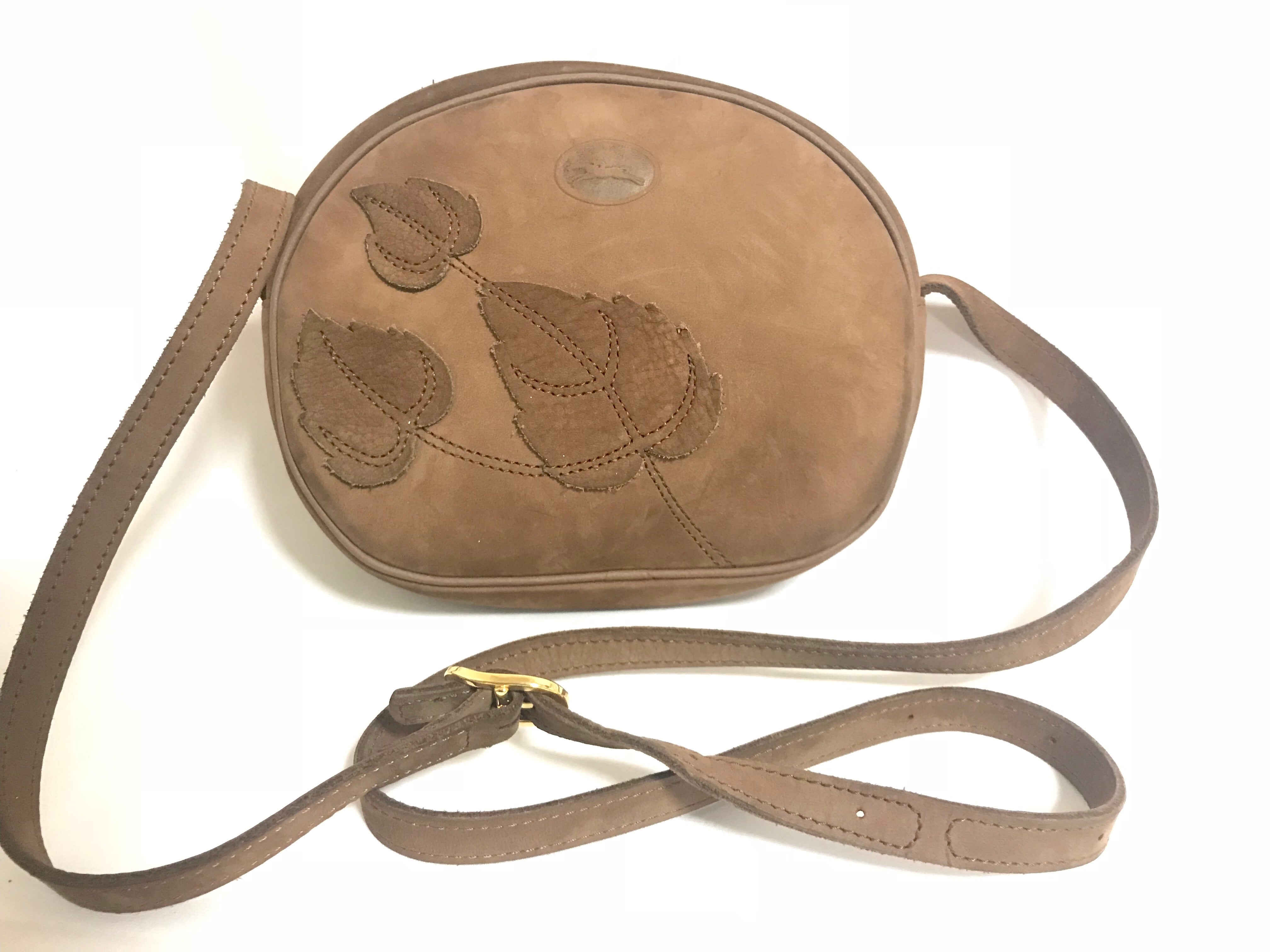 Vintage Longchamp brown suede leather oval round shape shoulder bag with leaf applique motifs. Rare and unique bag back in the okd era.
