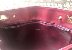 Vintage CHANEL wine leather tote bag with gold chain handles and CC motif charm. Classic purse.