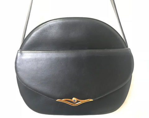 Vintage Cartier navy oval shape shoulder bag with blue stone and golden frame flap. Classic purse from Sapphire line.