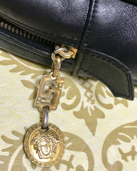 Vintage Gianni Versace black leather purse pouch, case bag with its iconic medusa face and golden logo motif charm. Unisex bag.