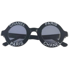 Vintage CHANEL black round frame mod sunglasses with white CHANEL PARIS logo.