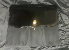 Vintage Christian Lacroix black patent enamel and nylon combo clutch bag with a sun flower shape logo motif.