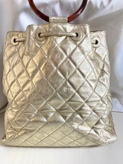 Vintage CHANEL campaign gold lamb leather hobo bucket bag with marble hoop handles and turn lock CC. 0412081