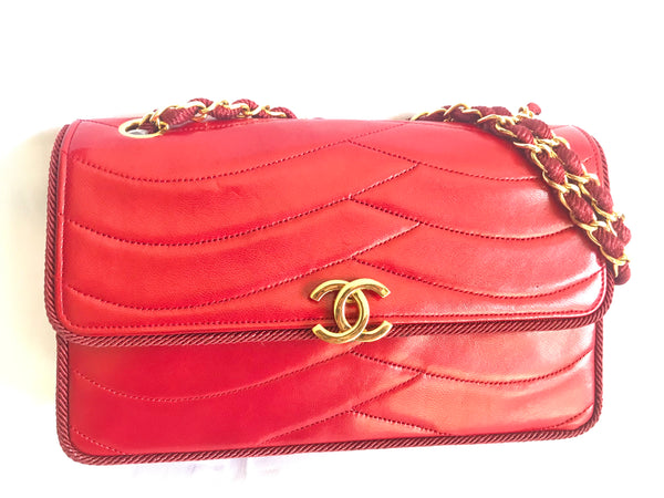Vintage Chanel red 2.55 shoulder bag with wavy stitches and rope strings  and gold chain strap. Very rare piece from the era. 050316r4