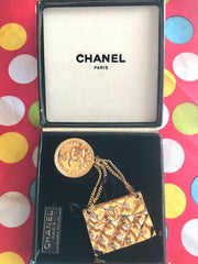 Vintage CHANEL Gold tone brooch with 2.55 classic purse and CC charms. Chic dangling brooch