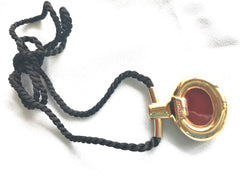 Vintage Hermes golden and red stone charm pendant top necklace with black strings. Unique jewel piece from PARFUM Collection.