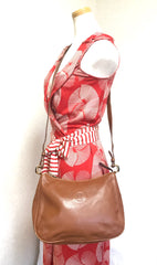 Vintage Fendi brown leather messenger shoulder bag with embossed logo and clear brown and golden motifs. Unisex.