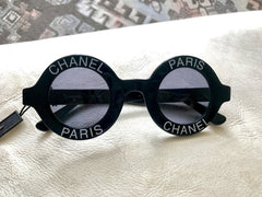 Vintage CHANEL black round frame mod sunglasses with white CHANEL PARIS logo.