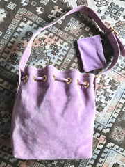 Vintage Christian Lacroix purple suede leather hobo bucket shoulder bag with drawstrings and golden sun, heart etc.. motifs. Unique and chic.