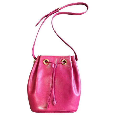 Vintage Valentino Garavani pink caviarskin type leather hobo bucket shoulder bag with round logo motifs and drawstrings.