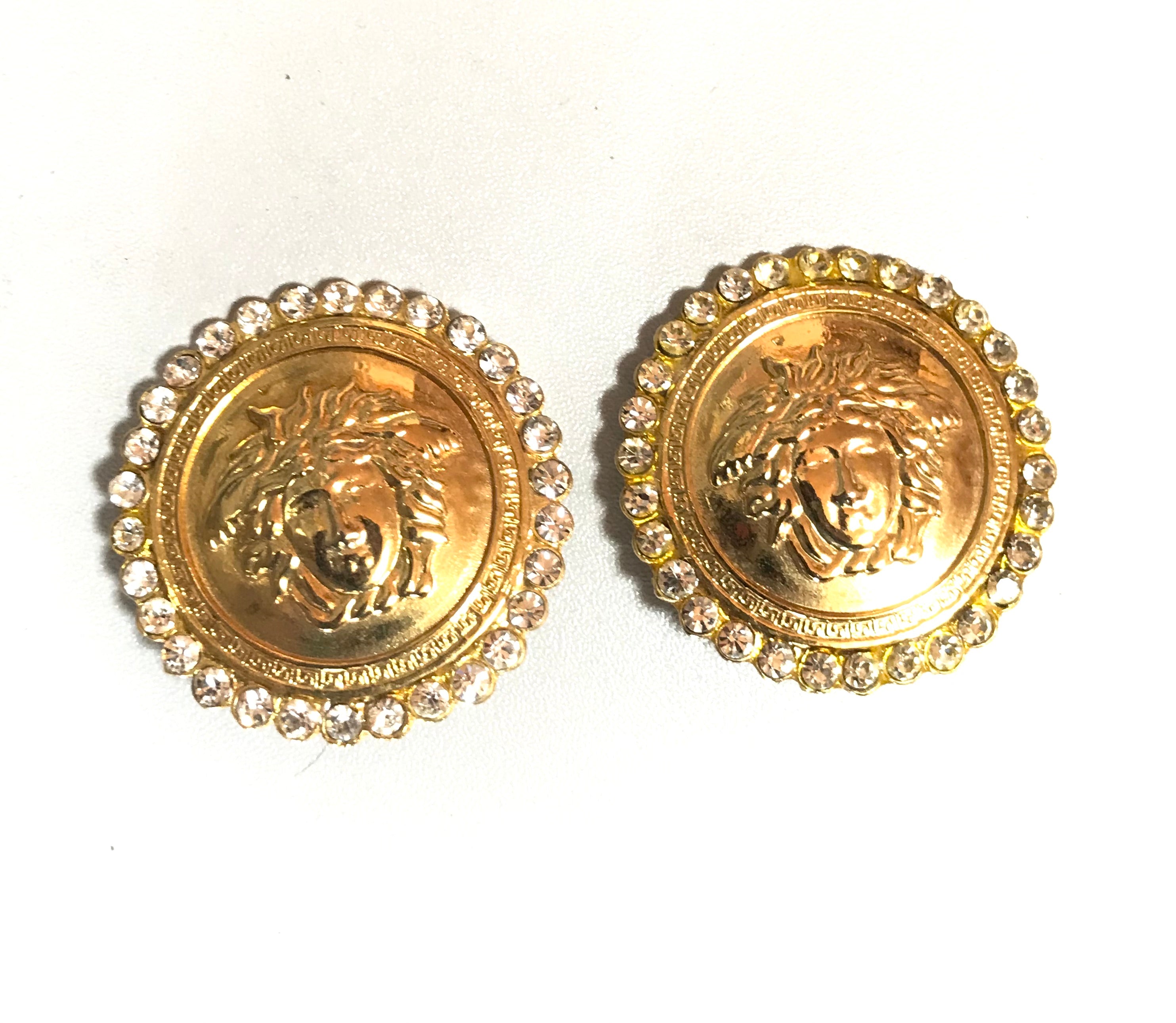 Vintage Gianni Versace large round gold tone medusa face earrings with crystal glasses. Must have Lady Gaga style jewelry piece.