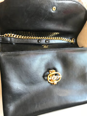 Vintage Gucci black leather shoulder bag with golden and silver tone GG logo motif. Classic purse. Can be clutch bag.