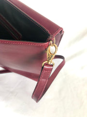 Vintage FENDI wine leather shoulder bag, large clutch purse with iconic Janus medallion embossed motifs at front. Unisex.