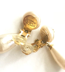 Vintage CHANEL white teardrop faux pearl dangle earrings with golden CC mark on top. Classic jewelry.