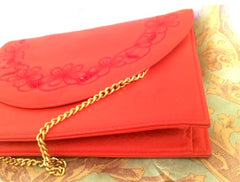 Vintage Valentino Garavani red leather clutch shoulder bag with red flower embroidery deco on the flap and V logo.