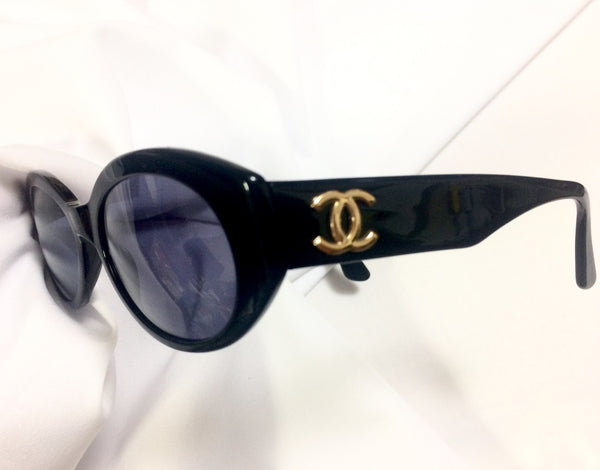 Vintage CHANEL black oval frame sunglasses with golden CC motifs