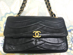 80's vintage Chanel black 2.55 shoulder bag with wavy stitches and rope strings and gold chain strap. Very rare piece from the era