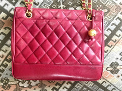 Vintage CHANEL cherry red caviar leather quilted shoulder bag, tote with golden CC ball and chain straps. Classic bag.