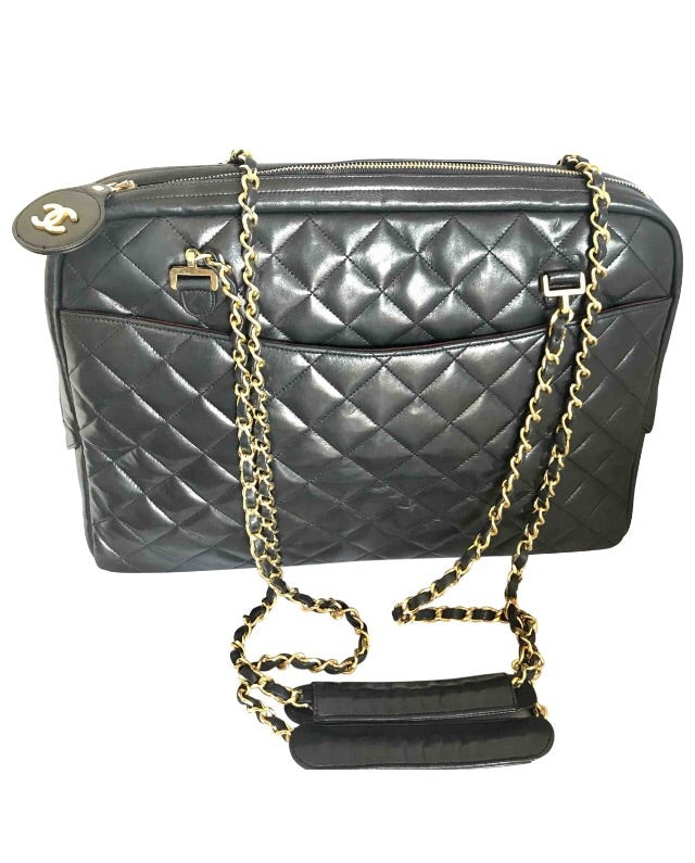 Vintage CHANEL black lamb leather large classic bag with double golden chain strap and a CC pull charm. Perfect daily bag.