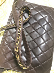 80's vintage Chanel dark brown quilted lambskin shoulder bag with CC motif and built-in chain shoulder strap. Rare Chanel purse
