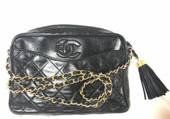 Vintage CHANEL black camera shoulder bag with CC mark stitch and tassel. Classic must have design purse.