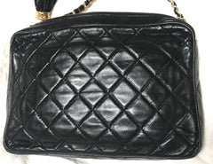 Vintage CHANEL black camera shoulder bag with CC mark stitch and tassel. Classic must have design purse.