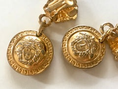 Vintage Gianni Versace gold tone medusa face motif dangle earrings. Must have Lady Gaga style jewelry piece. Great gift.