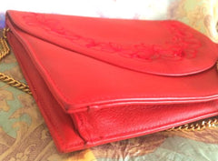 Vintage Valentino Garavani red leather clutch shoulder bag with red flower embroidery deco on the flap and V logo.
