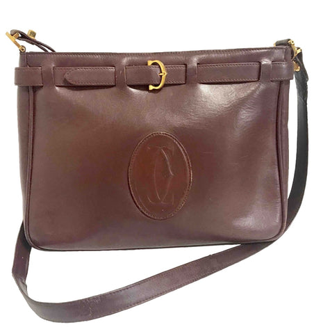 Vintage Cartier kelly style wine leather shoulder bag with a decorative built-in belt.  les must de cartier collection.