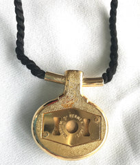 Vintage Hermes golden and red stone charm pendant top necklace with black strings. Unique jewel piece from PARFUM Collection.