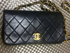 Vintage CHANEL black lambskin mini shoulder bag, classic 2.55 purse with gold tone CC closure.