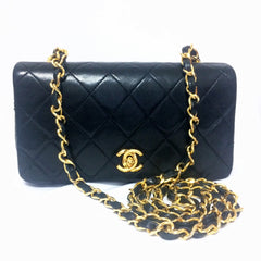 Vintage CHANEL black lambskin mini shoulder bag, classic 2.55 purse with gold tone CC closure.