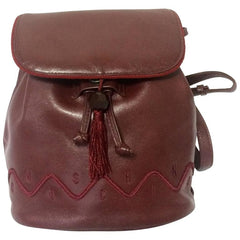 Vintage MOSCHINO genuine dark wine nappa leather backpack with tassel and logo embroidery motifs. Small to Medium size for daily use.