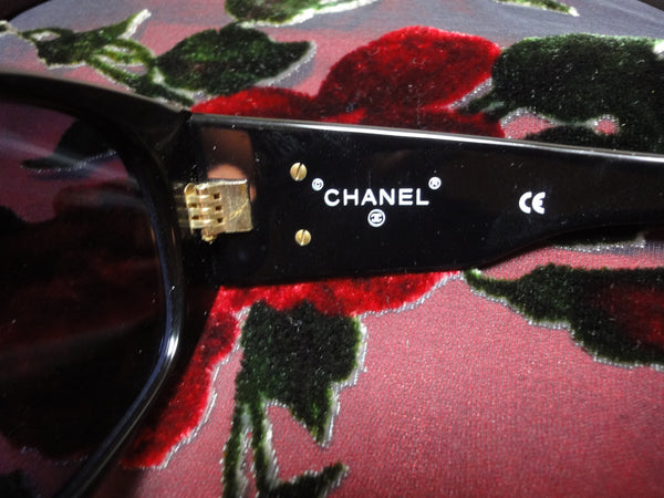Vintage CHANEL black frame sunglasses with large CC charms at