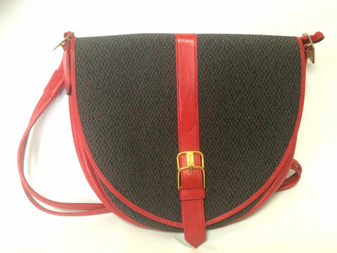 Vintage Yves Saint Laurent oval navy shoulder bag with red leather shoulder strap. Perfect daily use YSL purse.